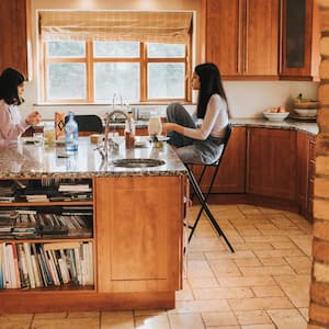 A family seating by a kitchen island enjoying a quick lunch