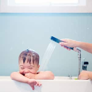 Mom bathing her toddler son