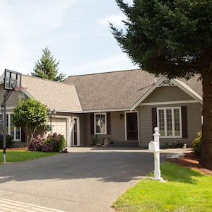 Suburban house with basketball hoop in driveway 