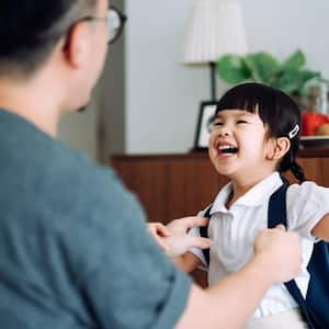 Girl getting dressed with her father