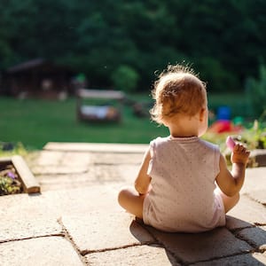 Baby sitting on paver patio