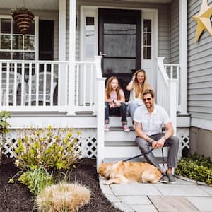 Family sitting in front of home