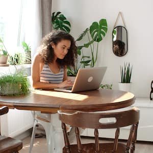 woman at home searching on laptop