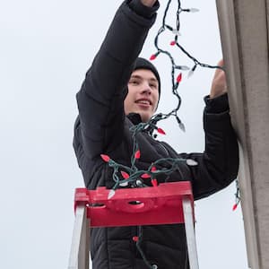 Handyman hanging Christmas lights