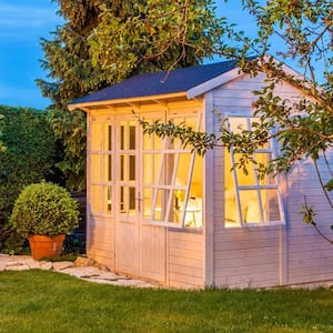 A garden shed illuminated at night