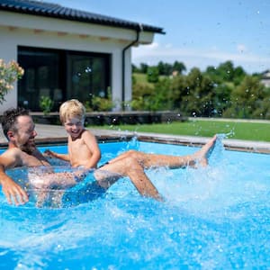 Father and son playing in swimming pool