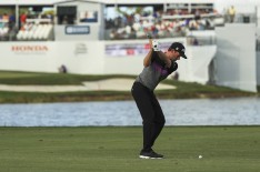 Webb Simpson plays his approach shot on the 16th hole during the third round of the Honda Classic