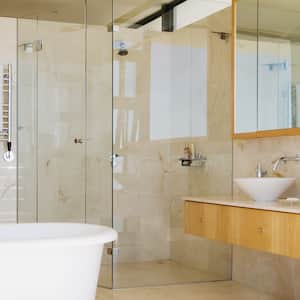 A modern large bathroom with a framed glass shower door