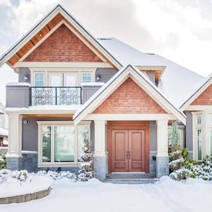 A suburban house covered in snow