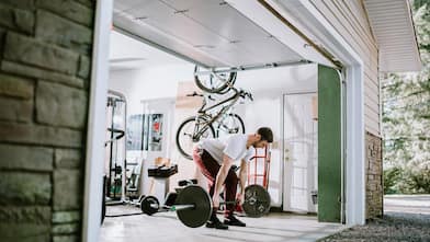 A man exercises in garage turned into home gym