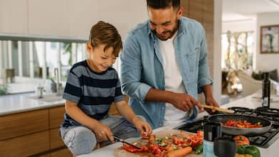 father and son cooking together in the kitchen   