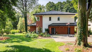 house exterior with with trees containing ivy 