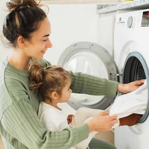 Mother and her daughter doing laundry