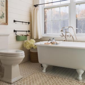 A bathroom with white roll top bath