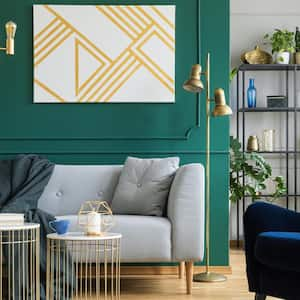 A living room with a sofa, an armchair and a golden light fixture