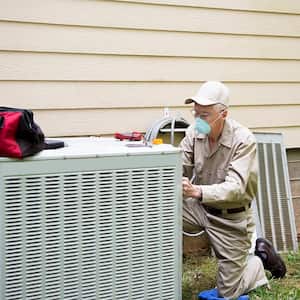 Man fixing air conditioner unite