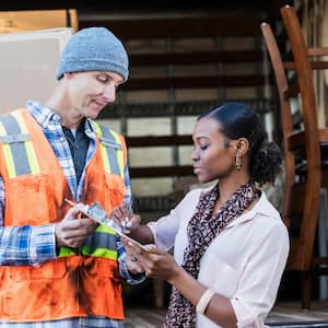 A homeowner signing paperwork with the moving company