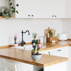 A modern u-shaped white kitchen