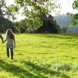 A family walks on grassy land