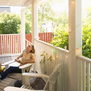 Woman relaxing in a chair on porch.