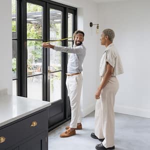 Couple measuring kitchen door