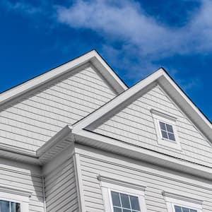 A house with a triangle roof and fiber cement siding