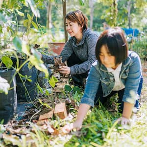 Mother and daughter clearing yard