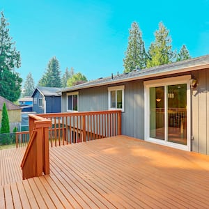 empty finished deck with double glass doors leading to home