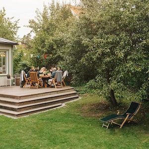 A family eats on a wooden deck