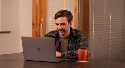 man sitting looking at laptop