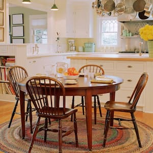 A traditional kitchen with wooden table, chairs and hardwood floor