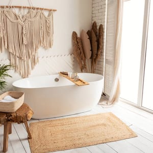 A cozy minimalist bathroom with a white bathtub