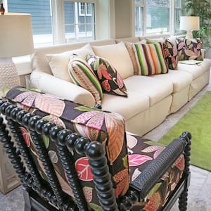 Attractive, uncluttered living room with couch and colorful chairs. 