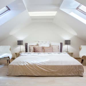 A minimal bedroom located in the attic of a house