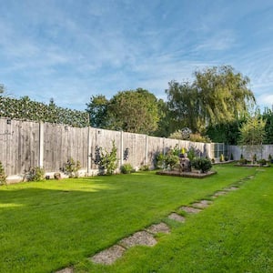 A property’s garden with lawn and timber fencing