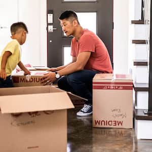 Father and son moving boxes