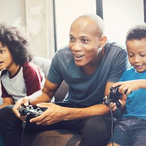 Father and kids playing video games