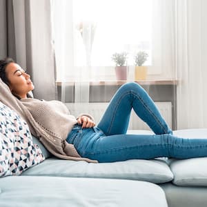 Woman relaxing on a sofa at home