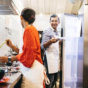 A couple cooking in the kitchen