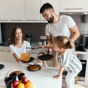 Family making breakfast in kitchenette