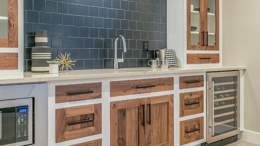 A kitchenette with blue tile backsplash