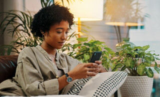 Woman lounging on couch looking at her phone