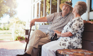 elderly man and woman sitting on bench