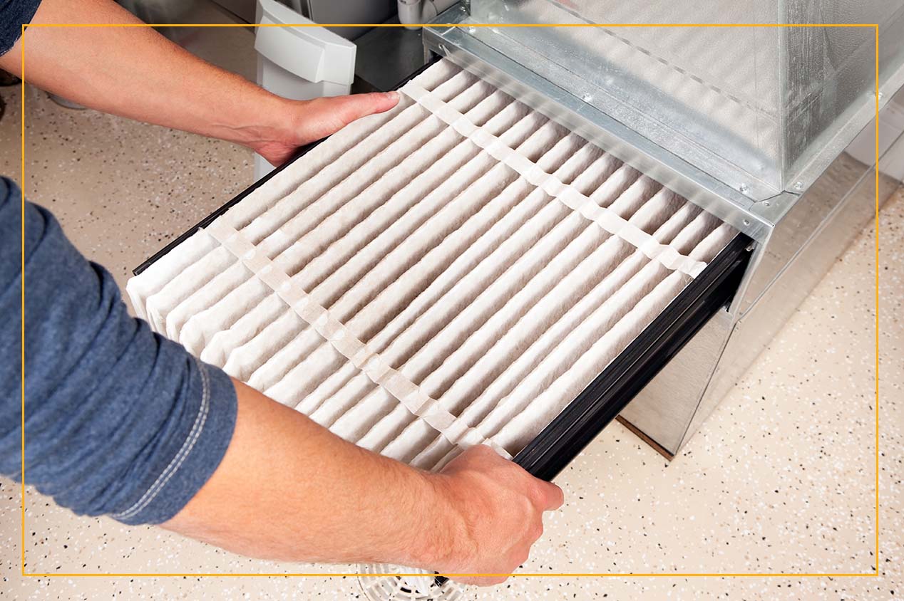 man changing furnace air filter