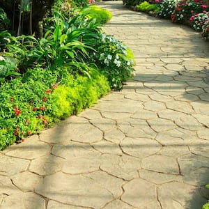 Stamped concrete walkway in a flower garden