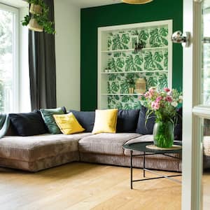 A modern living room with large windows and nature views