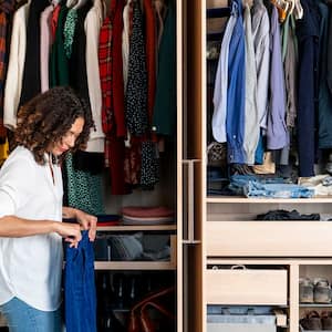 Woman in front of her closet folding her jeans