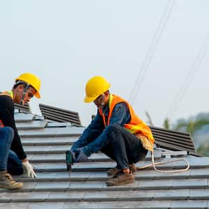 A professional workers installing a tile roof