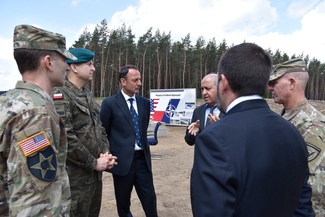 U.S. Army Corps of Engineers, Europe District Commander Col. Pat Dagon, Plenipotentiary to the Minister of Defense for the Enhanced Defense Cooperation Agreement Polish Brig. Gen. Dariusz Mendrala, NATO Investment Committee Chair Emanuele Meli, Europe District Chief of Program Management Branch Lalit Wadhwa, Europe District Chief of Programs and Project Management Justin Wetherwax and Poland Provided Infrastructure Program Manager U.S. Army Col. Eric McFadden discuss military construction efforts in Poland June 2, 2022 in Powidz ahead of the groundbreaking ceremony for the Munitions Storage Area being constructed there. The ceremony marked the beginning of the Poland Provided Infrastructure program, which provides a mechanism for sharing the costs for U.S. forces in Poland. Infrastructure projects are funded by Poland and are designed and constructed to meet U.S. requirements for use by U.S. forces operating in Poland. For its part, the U.S. will continue to bear the costs of training, equipping, deploying and employment of U.S. forces in the country. (U.S. Army photo by Chris Gardner)