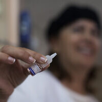 A file photo from 2013 shows a worker holding a polio vaccine at a medical center in Jerusalem. (Yonatan Sindel/Flash90)